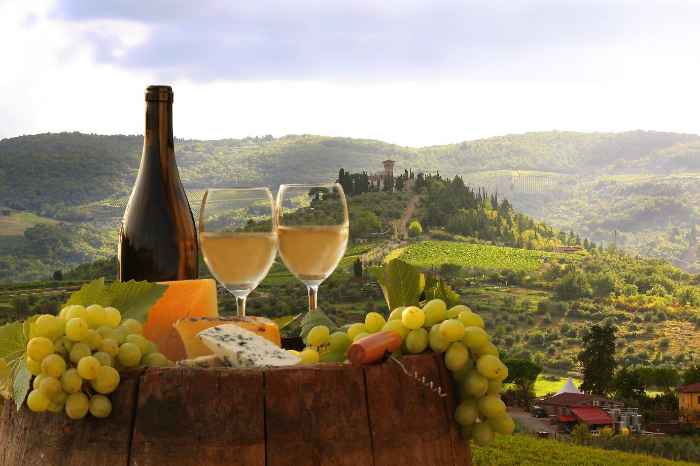 White wine with barrel on famous vineyard in Chianti, Tuscany, Italy