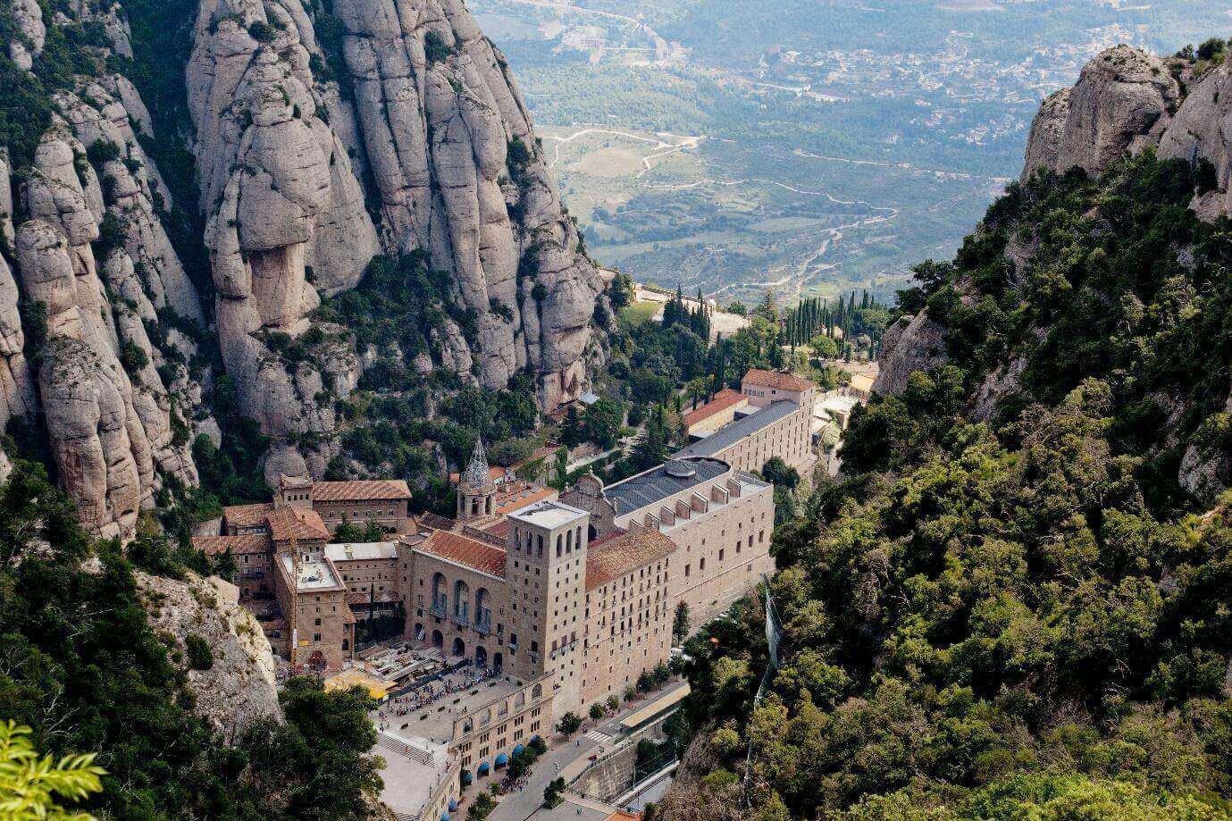 Rocky city in the mountains of Montserrat, panorama, top view of the city, bright greenery and beautiful views.