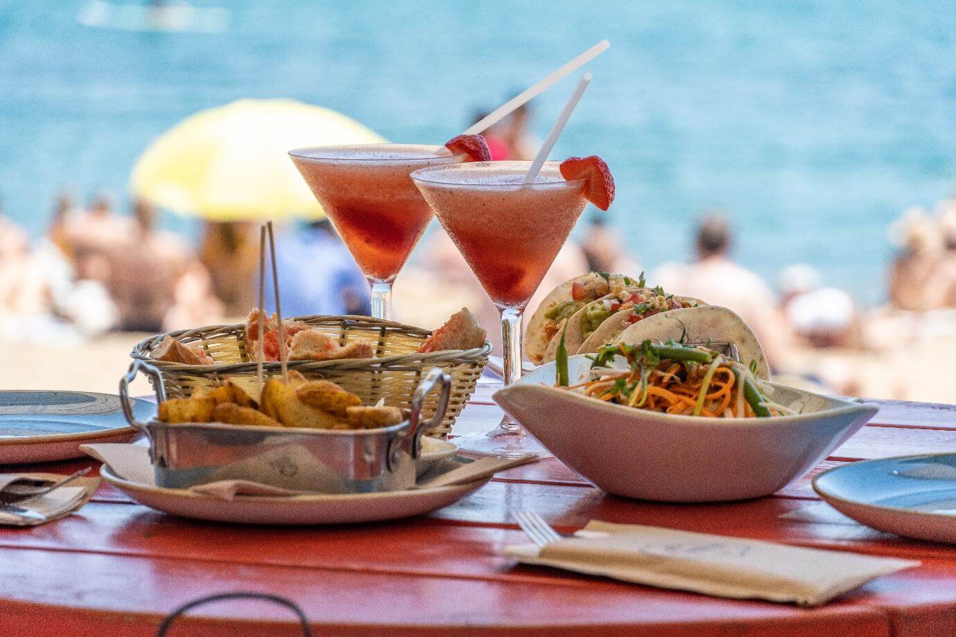 This is a delicious lunch plating on a red table at the beach in Barcelona