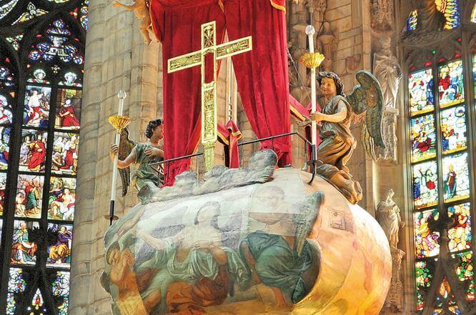 Internal view of a church in Milan, Italy with a cross.