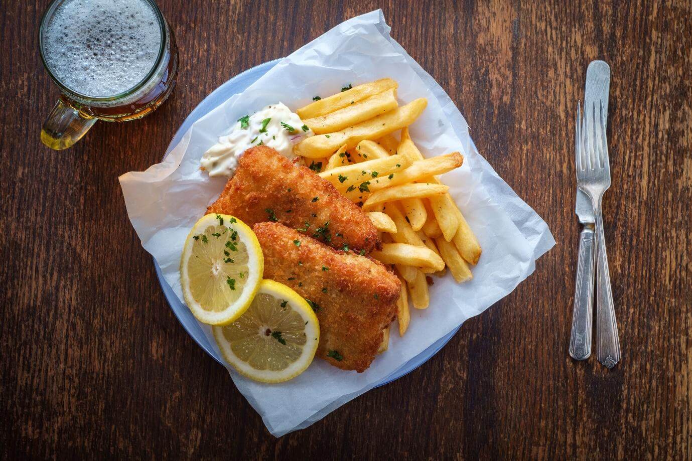 Authentic traditional British cuisine fish and chips served with an ice cold beer.